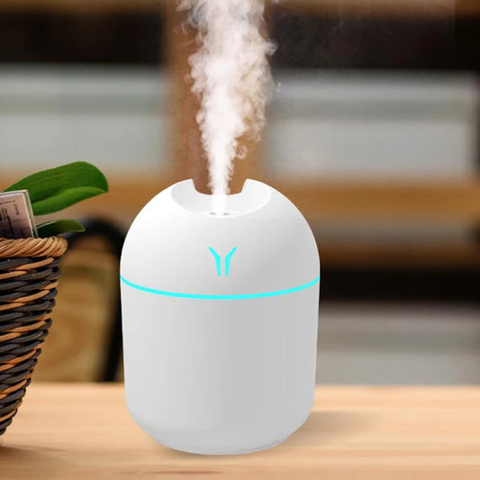 Velmora Living USB mini air humidifier with aroma essential oil diffuser, compact device for adding moisture and scent to a space.